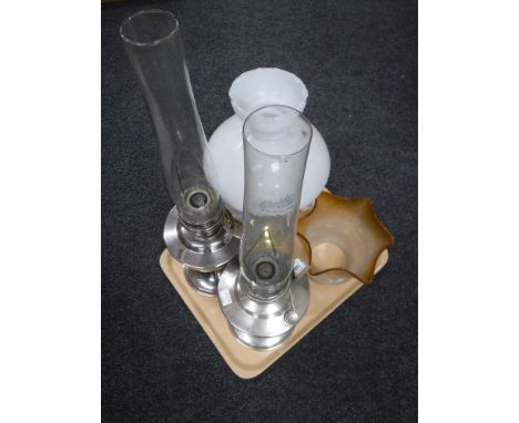 A tray of two chrome Aladdin oil lamps with chimneys together with a brass oil lamp with shade and another antique oil lamp s