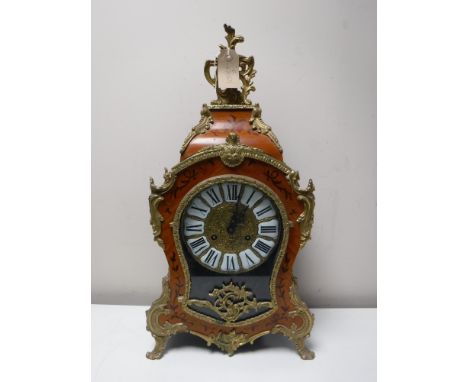 An ornate Franz Hermle mantel clock with pendulum and key 