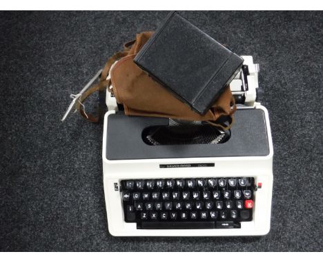 A case Silver Reed 500 typewriter and an Agfa camera 