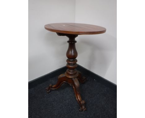 An oval mahogany occasional table on three way tripod base 