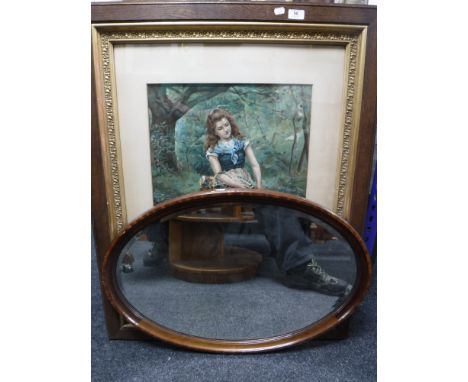 An Edwardian oak and gilt framed print - girl picking flowers and an oval framed mirror 