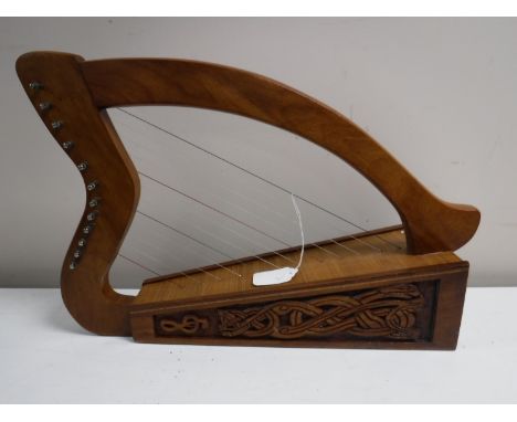 A carved miniature twelve string harp 