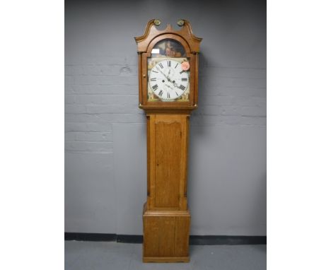An oak eight day longcase clock with painted dial signed W. Easton, Newcastle Upon Tyne, with pendulum and weights 