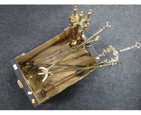 A box of four piece brass companion set, antique fire irons, toasting fork etc 