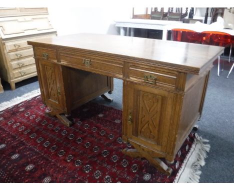 An Edwardian oak twin pedestal desk 