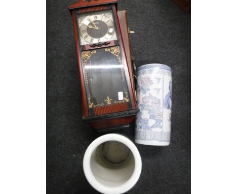 A mid 20th century luggage case together with a Rhythm wall clock and a pair of oriental style stick stands