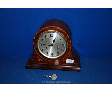 A pretty Mahogany domed Mantle Clock with two train movement and the case having decorative inlay
