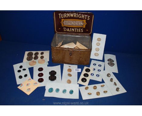 An old 'Turnwrights' Devon cream 'Dainties' tin and a quantity of vintage buttons and belt clasps.