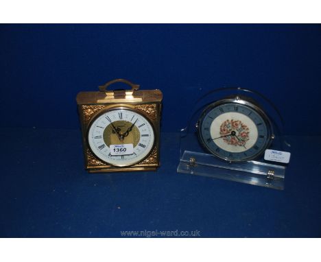 A heavy brass Tempora Mantle Clock along with a perspex mantle Clock with embroidered face