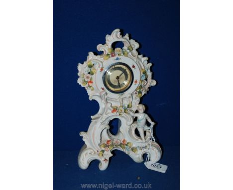 A clockwork mechanism circular Arabic numeral surround Mantle Clock in ornate ceramic mount in the form of a cherub and roses