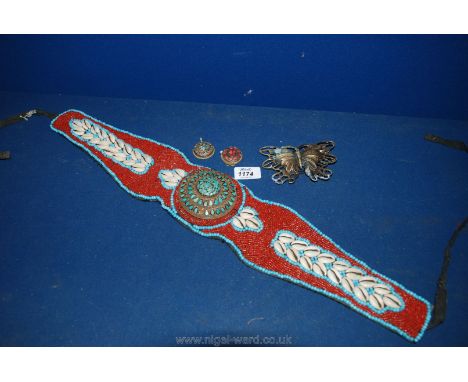 A Tribal beaded Belt, two enamel pendants and a butterfly belt buckle