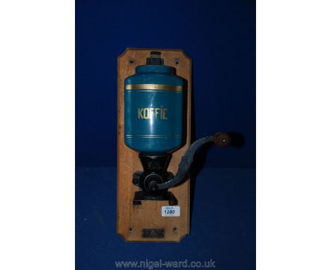 A vintage wall mounted Coffee Grinder.