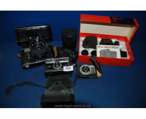 A box of Cameras and equipment including a Zenit EM Moscow 1980 special edition SLR Camera in leather case with Helios 44M le