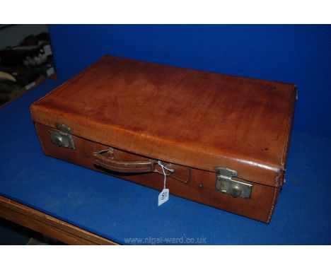 A tan vintage Leather Suitcase