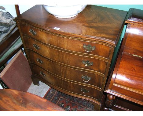 A reproduction Georgian style Walnut finished serpentine Chest of four Drawers, well figured half-veneered moulded edge top o