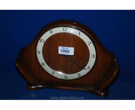 A 1950's Walnut clockwork Mantle Clock, white ring face with Arabic numerals on plinth base, 10 5/8" wide x 7 3/4" high x 2" 