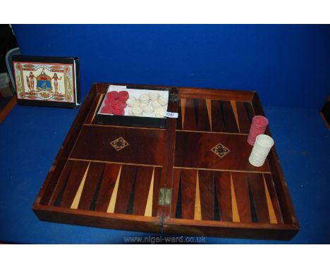 A Mahogany Marquetry Backgammon and Chess Board with two Chinese carved Ivory dice shakers, one white, the other red, plus si