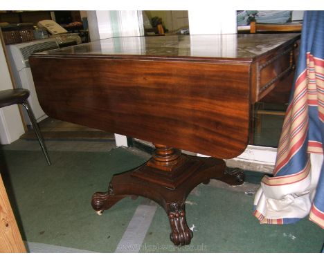 An elegant Regency Mahogany Sofa Table having rectangular top with two rounded corner drop leaves on pivoting swing arms, wit