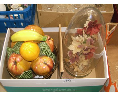 A Vintage glass dome with dried flowers and ceramic fruit bowl.