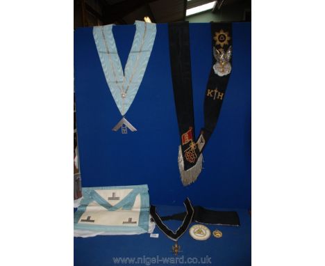 Two Black Masonic Sashes and a Cumberband and a pale blue and white Sash and Apron, the sash having a silver dropper inscribe