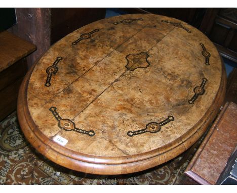 A Victorian Walnut, inlaid Looe Table, the oval snap top having central boxwood and ebony floral and geometric inlaid motif, 