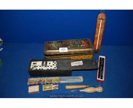 An old Tin containing a Swan fountain pen, pen nibs, dominoes, Attwood of Lewes thermometer, etc.