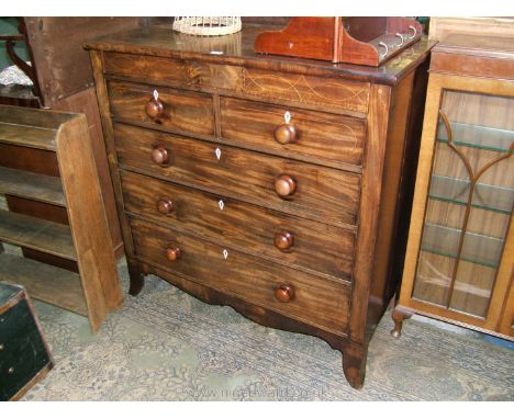 An early 19th c. Mahogany Chest of seven Oak lined drawers, with two inlaid secret frieze drawers, over two short over three 