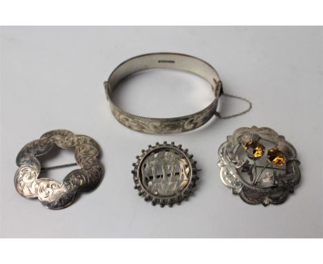 Hallmarked silver bangle, 29 grams, Scottish silver brooch and two other brooches 