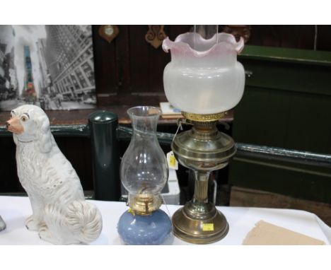 Brass oil lamp with glass shade and another with blue glass reservoir