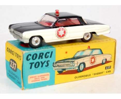 Corgi Toys, 237 Oldsmobile 'Sheriff' car, black body with cream side panels, red interior with roof light, 'County Sheriff', 