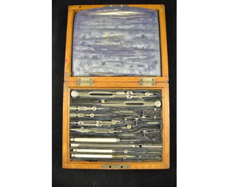 A late 19th/early 20th century Stanley oak cased set of drawing instruments, including ivory folding rule, scale rule and rol