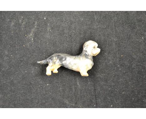A Royal Worcester pin brooch in the form of a dachshund, restored - L6.5cm