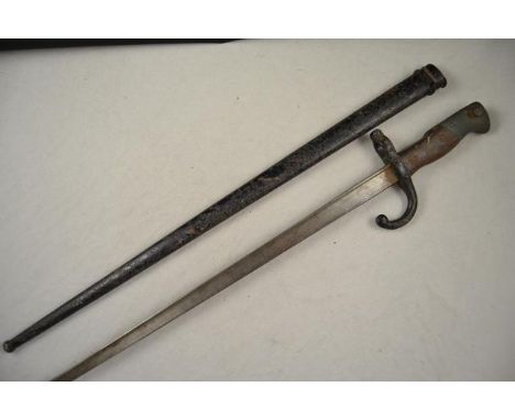 A late 19th century bayonet in scabbard, 52cm blade inscribed and dated 1877CONDITION REPORTBlade slightly misshapen on tip, 