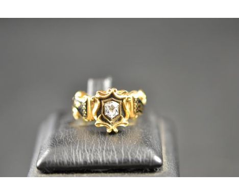 A Victorian 18ct gold mourning ring, central shield design set with rock crystal and bearing inscription to reverse, mounted 