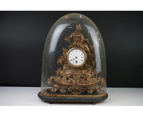 French Gilt Metal Figural Clock surmounted by a seated lady holding a sheath of corn, the white enamel face with Roman numera