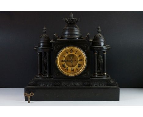19th Century slate mantle clock with Roman numerals on a brass dial, flanked by two four-column architectural structures hous