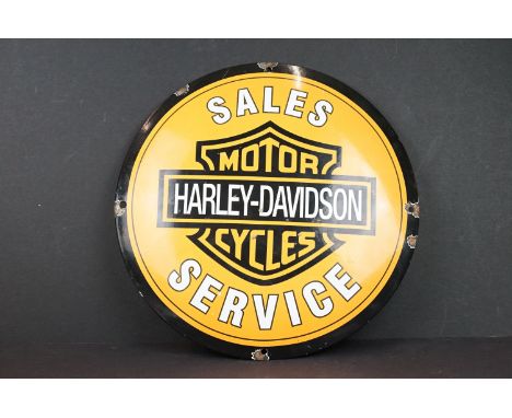 A Harley Davidson Sales &amp; Service circular enamel sign with four mounting holes, measures approx 29.5cm. 