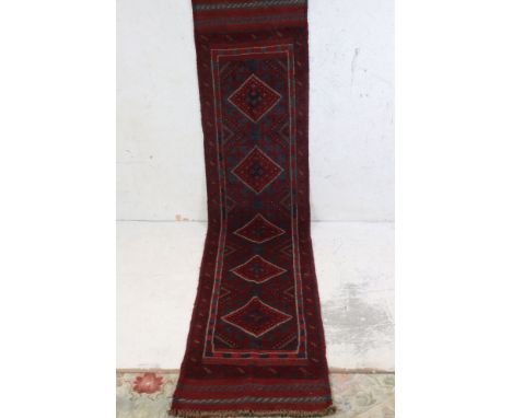A hand knotted wool Meshwani runner, measures approx 250cm x 56cm 