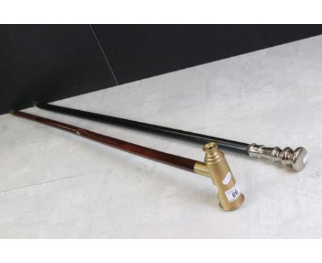 Walking Stick mounted with a brass three drawer telescope together with an Ebonised Walking Stick with White Metal Handle 