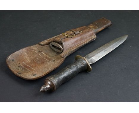 A World War One trench knife made from a damaged knuckle duster knife, original blade with skull crusher pommel, carved cork 