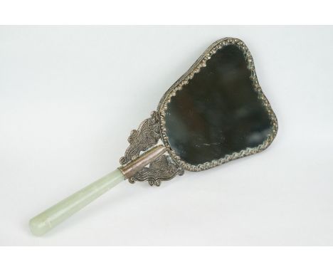 A Chinese silver plate on copper hand mirror with jade handle and turquoise centre stone. 