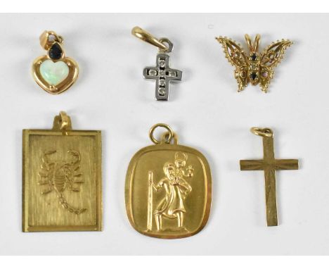 Two 9ct yellow gold pendants, one decorated with a religious scene, the other with a scorpion, a 9ct yellow gold butterfly pe