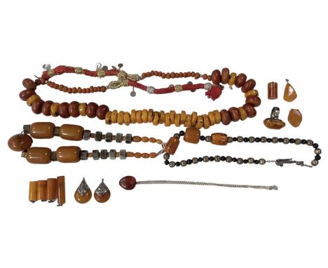 A group of amber and amber effect jewellery including necklaces, ring, pendants, pendant on necklace, etc.