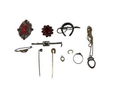 A small quantity of costume jewellery, including two red stone set brooches, bar brooch, white metal brooch modelled as a hor