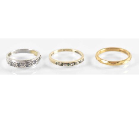 A 9ct white gold diamond and blue stone set ring, size L/M, a 9ct yellow gold diamond and emerald set ring, size N, and a fur