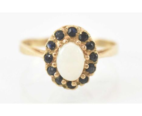 A 9ct yellow gold opal and garnet set ring, size M, approx 1.9g.