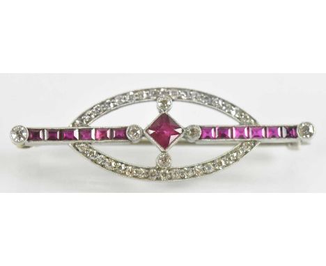 A white metal Art Deco style diamond and ruby set brooch, the central ruby approx 0.4ct, total ruby weight approx 1ct, surrou