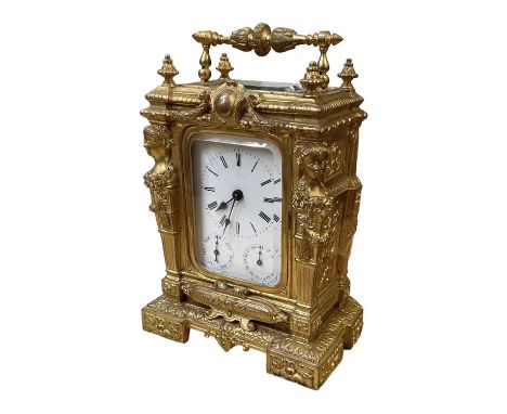 A 19th century French elborate gilt metal cased carriage clock, the white enamel dial set with Roman numerals, enclosed in a 