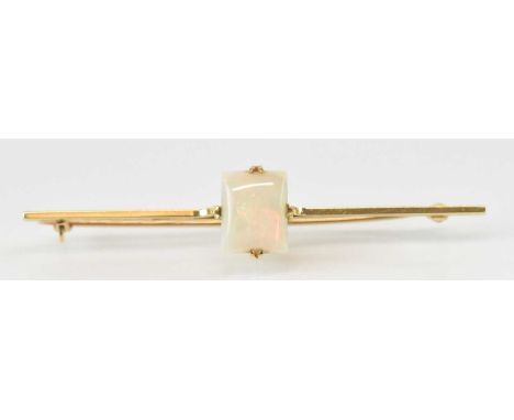 A 15ct yellow gold opal set bar brooch, the central opal approx 2ct, length 5.5cm, approx 3.1g.