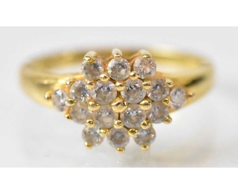 A yellow metal cluster ring set with sixteen small white stones, size M, approx 4.3g.